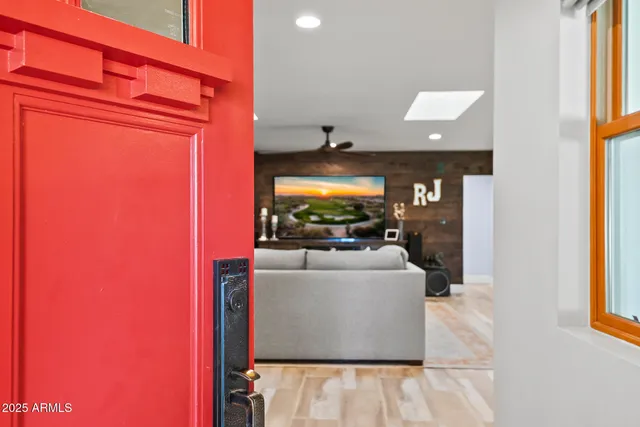 a living room with furniture and wooden floor