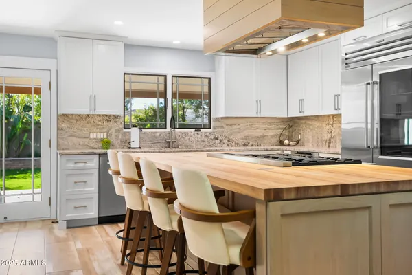 a kitchen with a stove a refrigerator and a sink