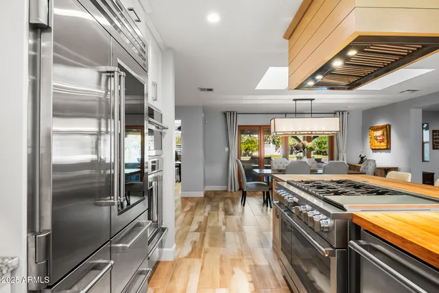 a kitchen with stainless steel appliances granite countertop a stove and a refrigerator