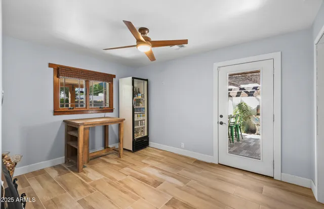 a kitchen with white cabinets and refrigerator