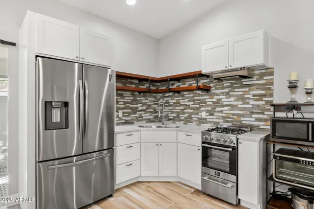 a front view of a house with a garden and trees