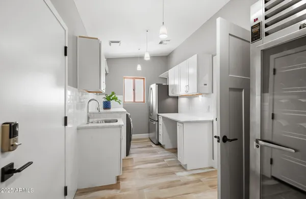 a view of a backyard with table and chairs potted plants