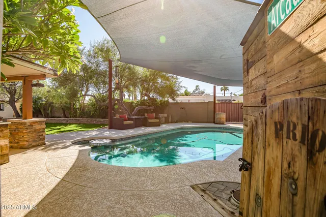 a view of a backyard with table and chairs and potted plants