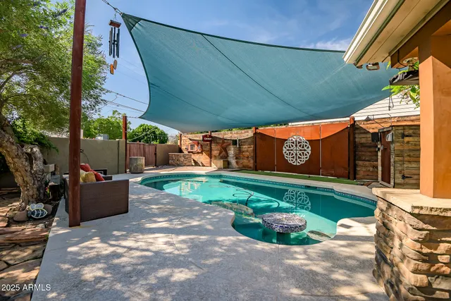 a bathroom with a granite countertop sink and a window