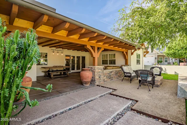 a view of a patio with table and chairs and potted plants