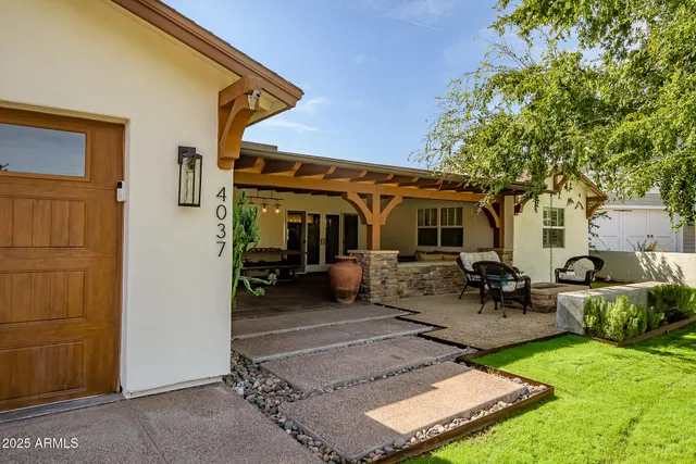 a view of a house with backyard sitting area and porch