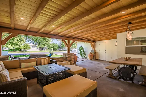 a backyard of a house with table and chairs