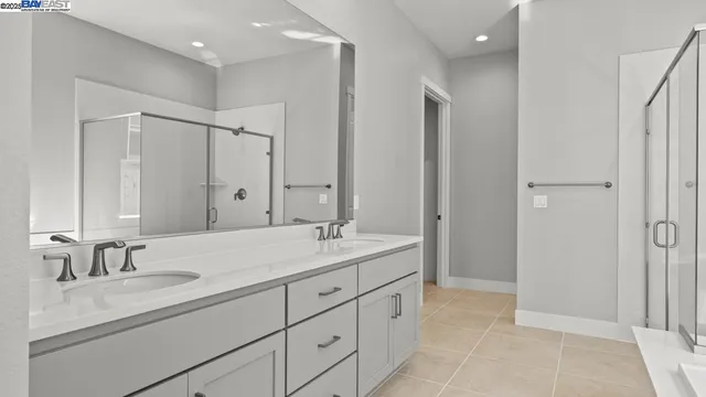 a bathroom with double sink and a mirror