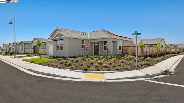 a view of a house with a small yard and plants