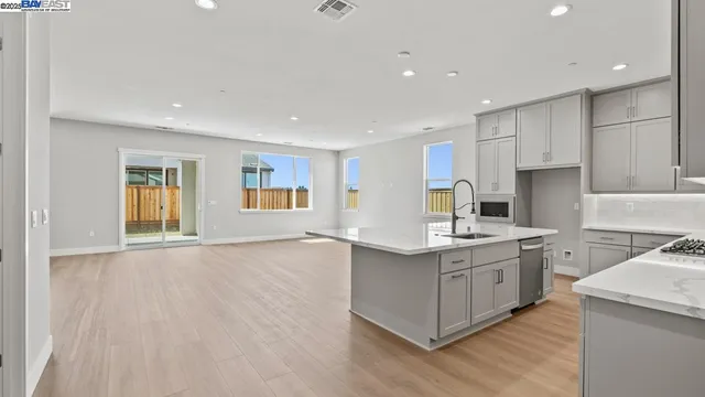 a kitchen with a stove and a white cabinets