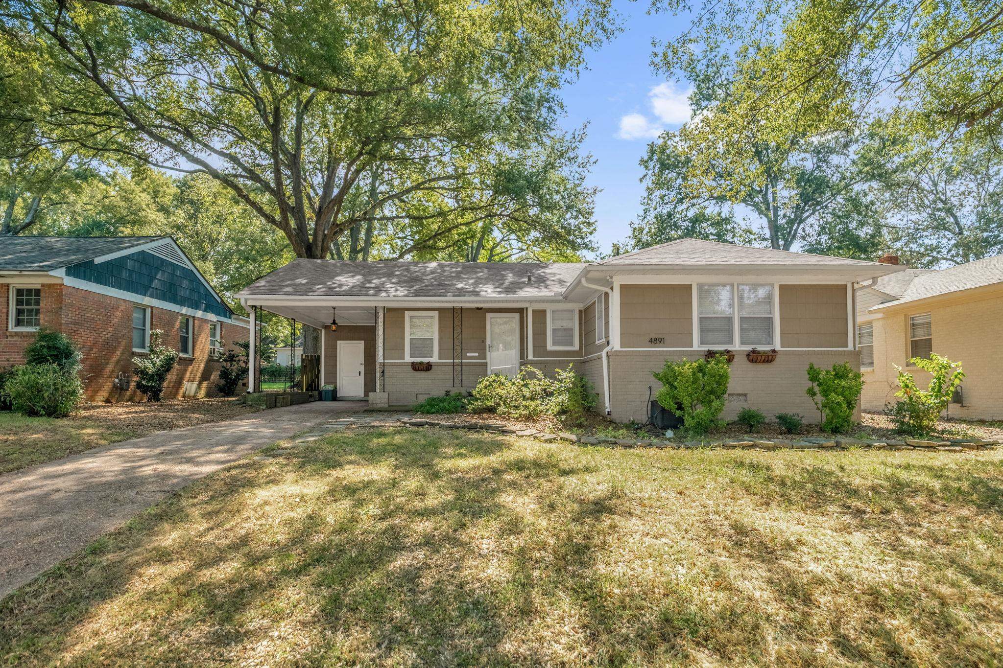 4891 Flamingo Road Memphis, TN 38117 - Photo 1 of 34 a front view of a house with a yard