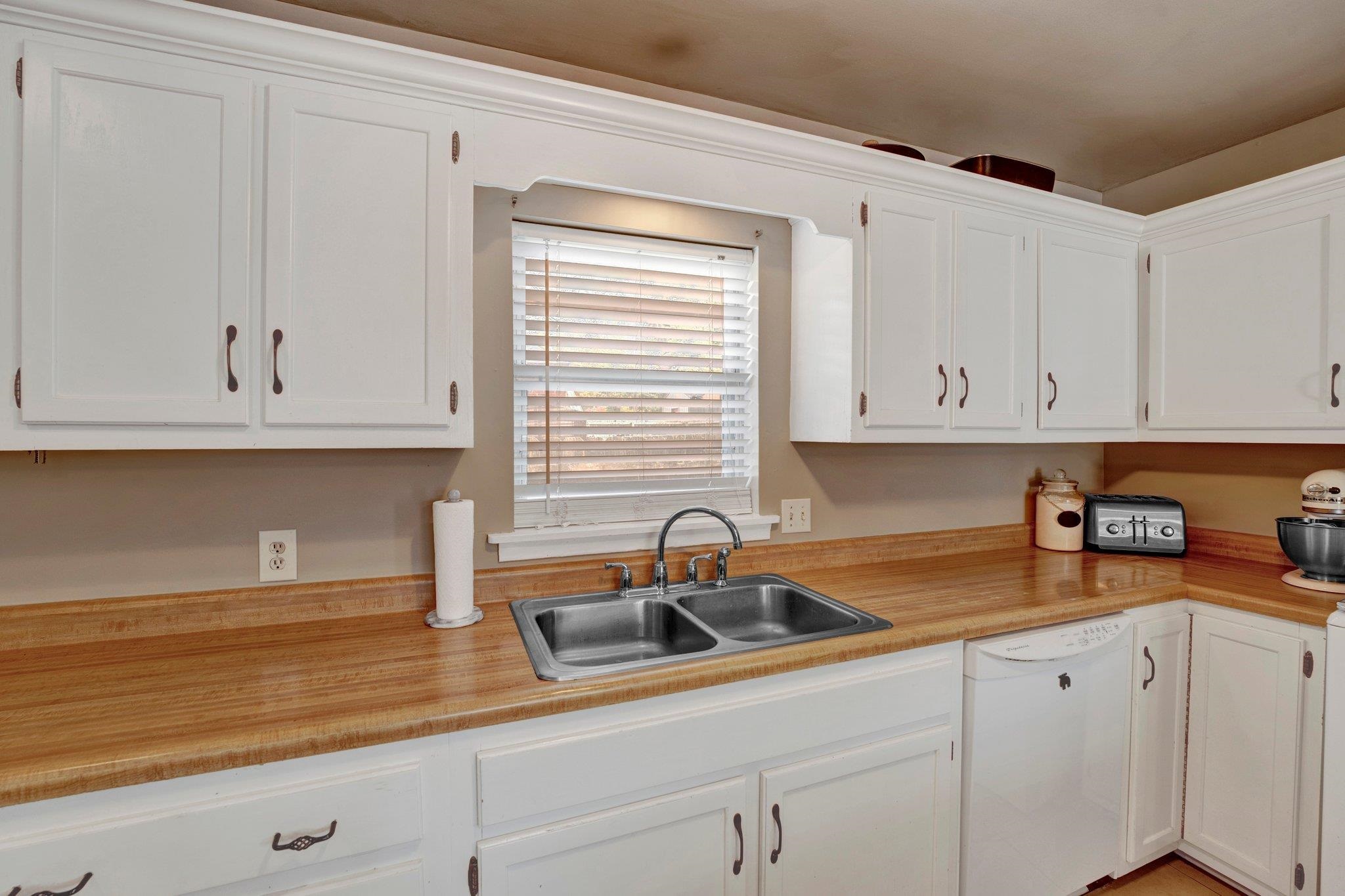 4891 Flamingo Road Memphis, TN 38117 - Photo 18 of 34 a kitchen with white cabinets and a sink