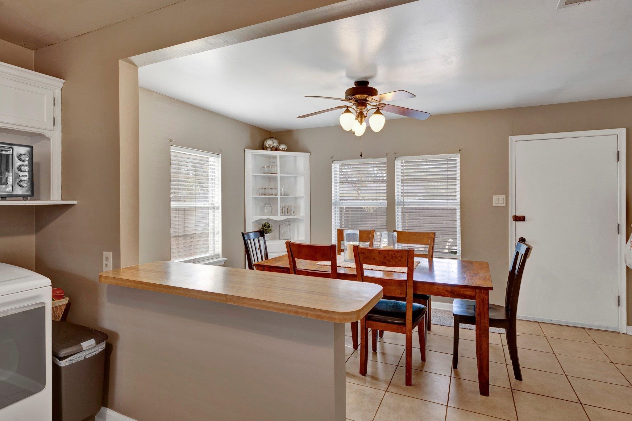 4891 Flamingo Road Memphis, TN 38117 - Photo 19 of 34 a view of a dining room with furniture a chandelier and wooden floor