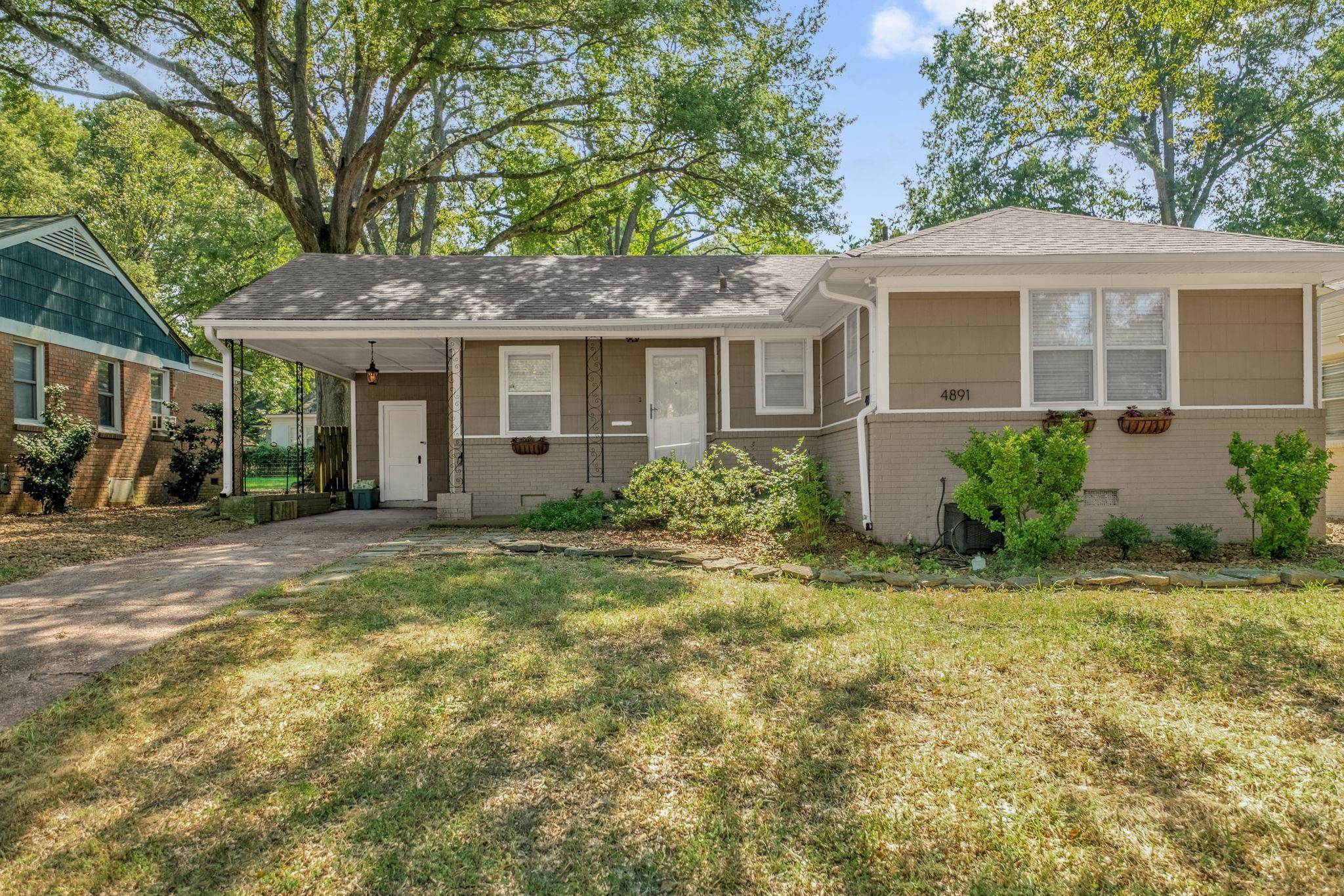 4891 Flamingo Road Memphis, TN 38117 - Photo 2 of 34 a front view of a house with garden