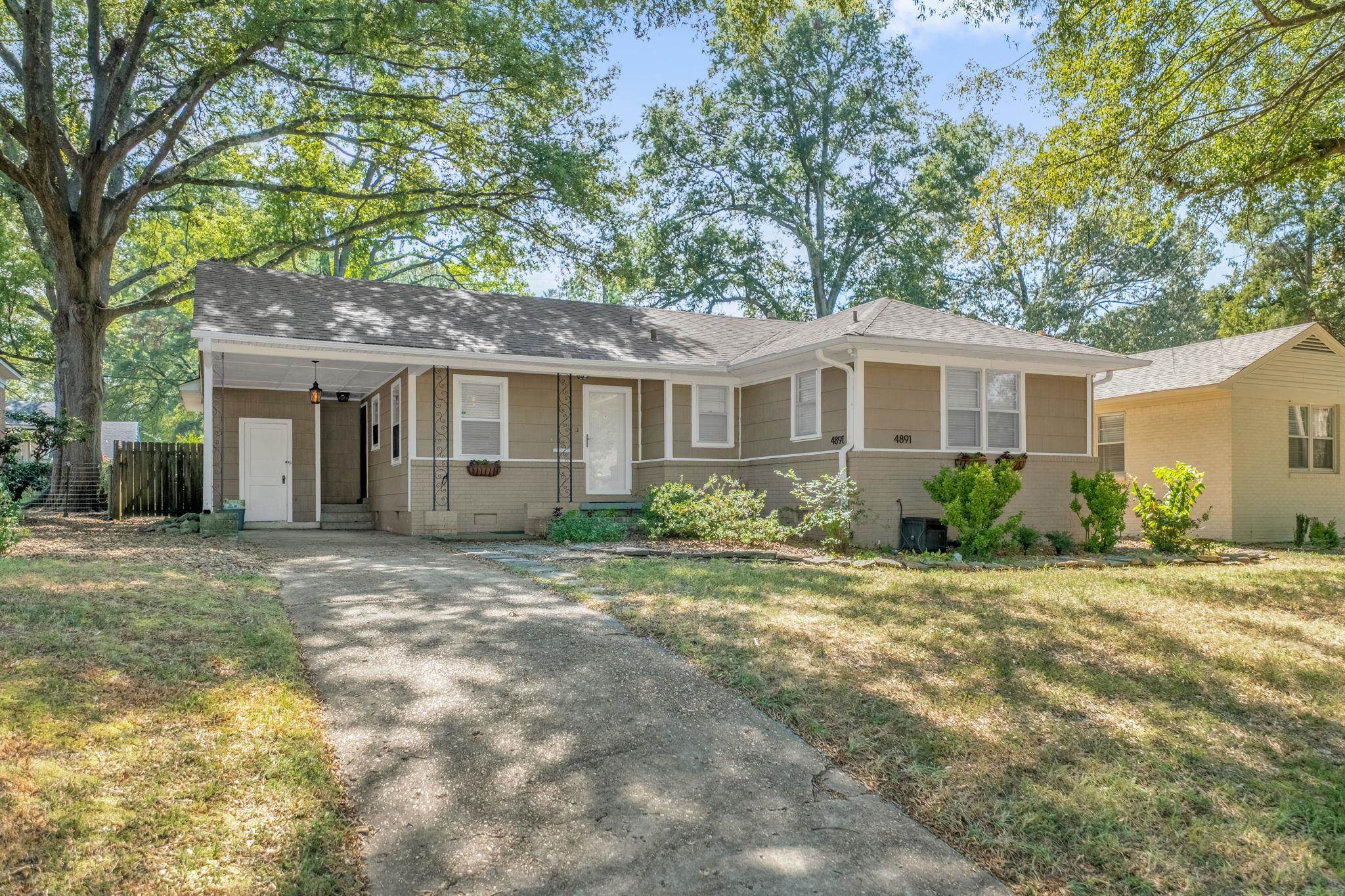 4891 Flamingo Road Memphis, TN 38117 - Photo 5 of 34 a front view of a house with a garden