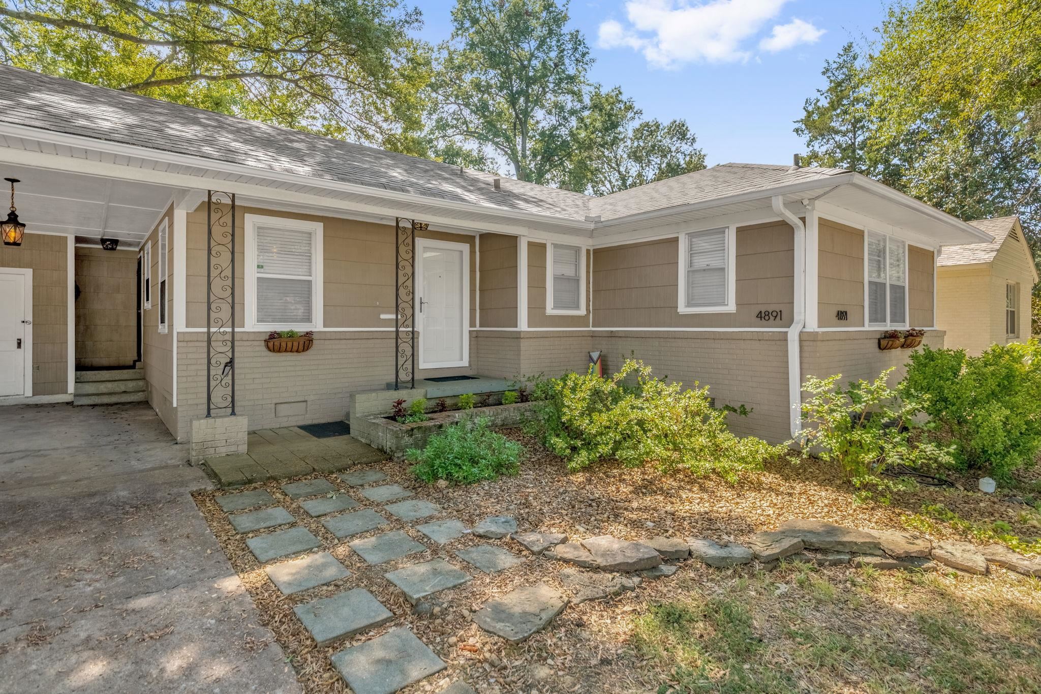 4891 Flamingo Road Memphis, TN 38117 - Photo 6 of 34 a front view of a house with garden