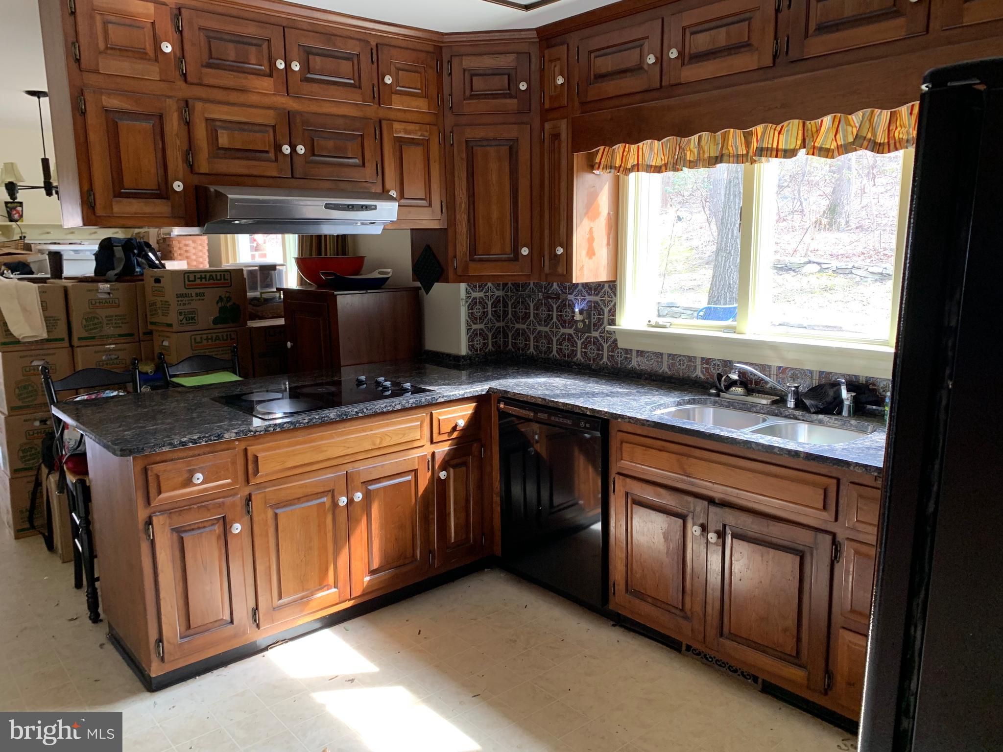 7603 Irongate Lane Frederick, MD 21702 - Photo 15 of 43 a kitchen with stainless steel appliances granite countertop a sink and a stove