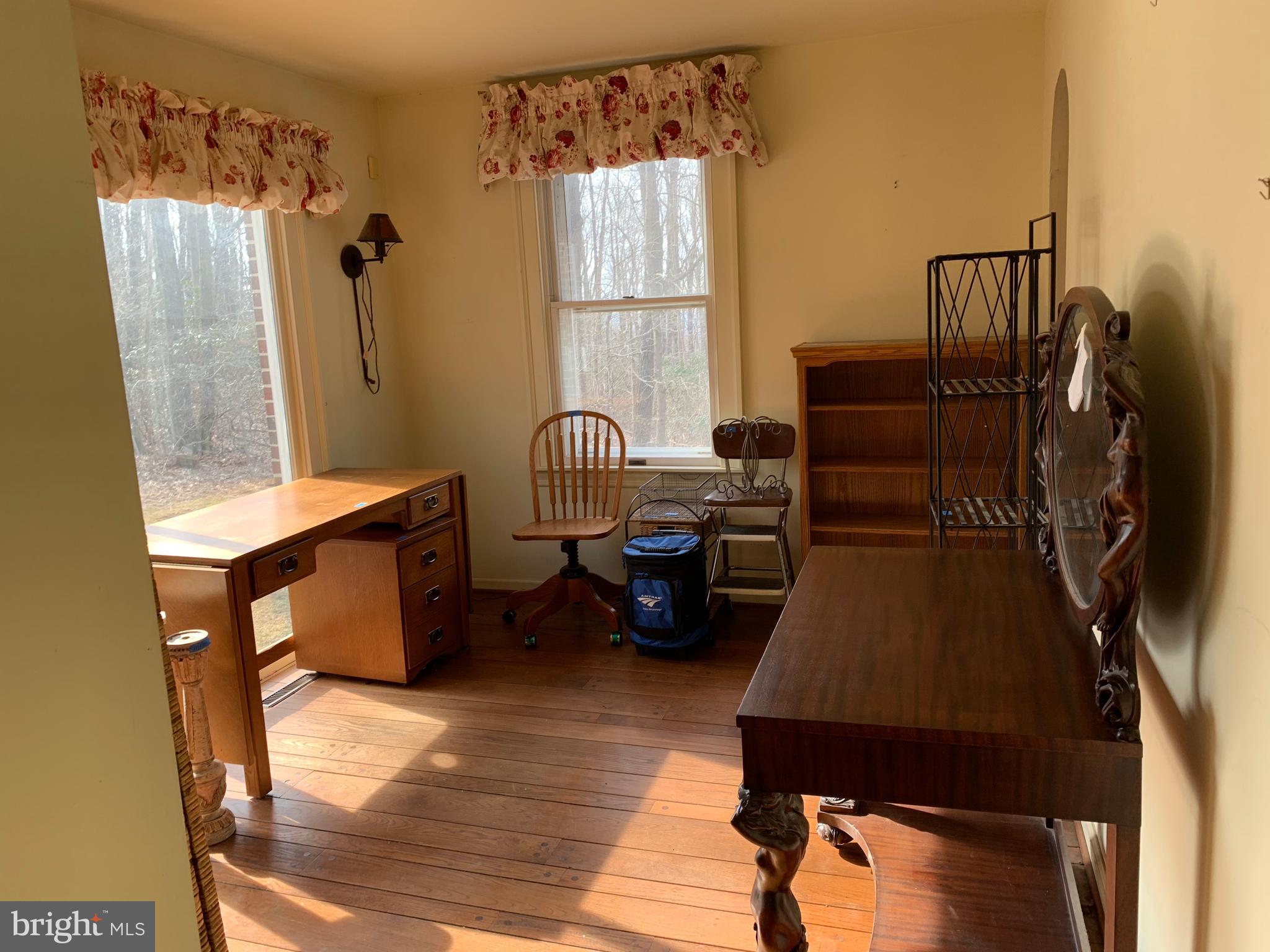 7603 Irongate Lane Frederick, MD 21702 - Photo 21 of 43 a living room with furniture a window and a wooden floor