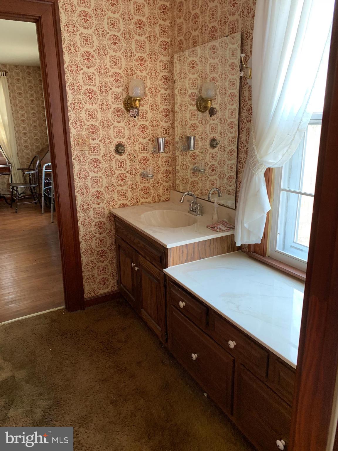 7603 Irongate Lane Frederick, MD 21702 - Photo 29 of 43 a bathroom with a sink a mirror and a shower