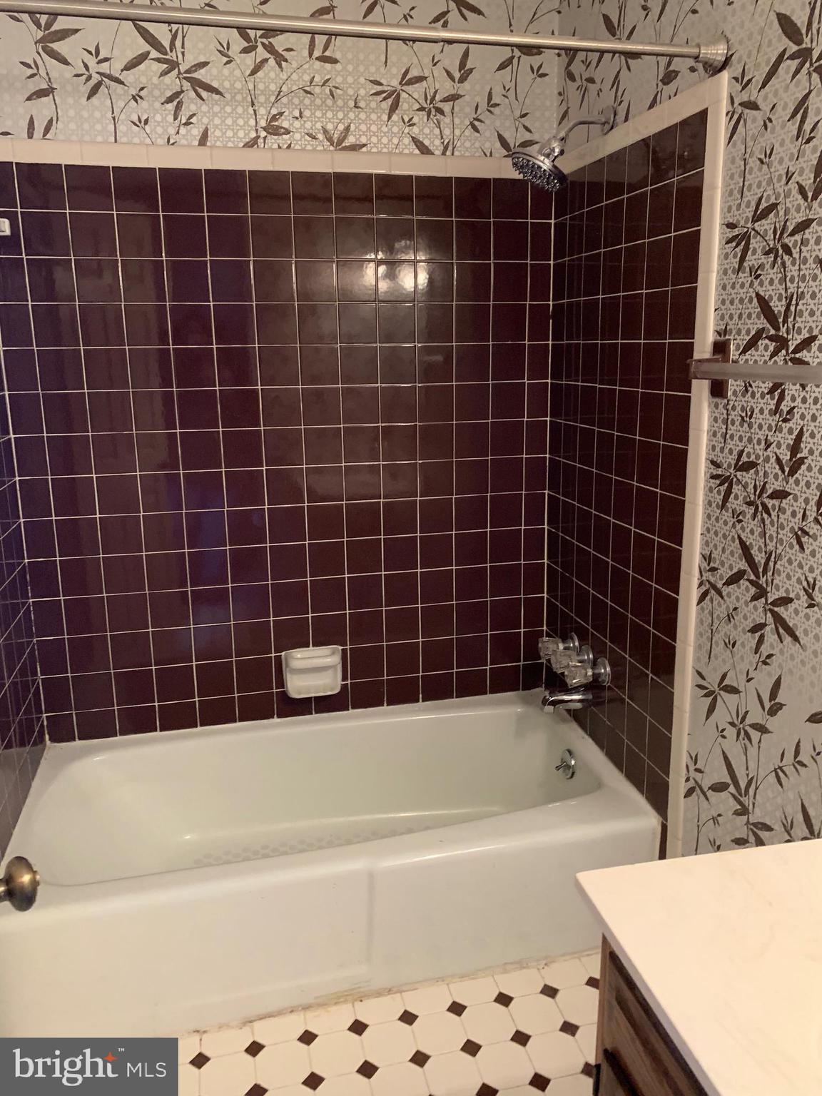 7603 Irongate Lane Frederick, MD 21702 - Photo 31 of 43 a bathroom with a bathtub and a shower