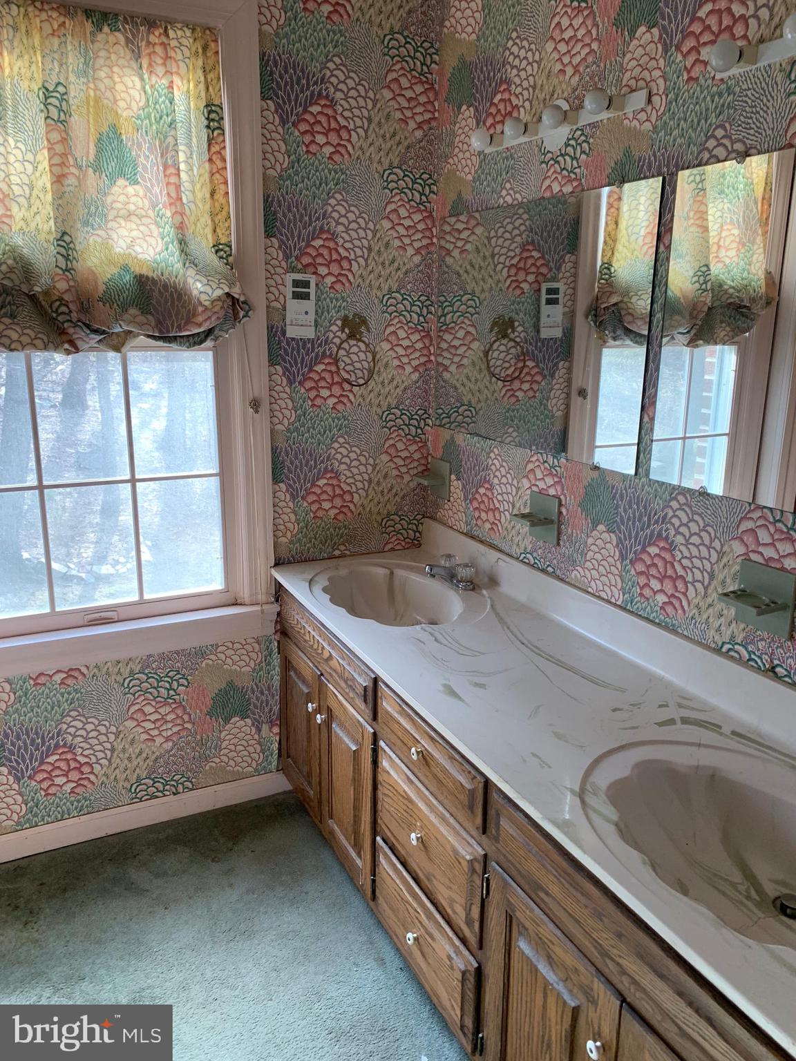 7603 Irongate Lane Frederick, MD 21702 - Photo 32 of 43 a spacious bathroom with a granite countertop sink a mirror and a shower