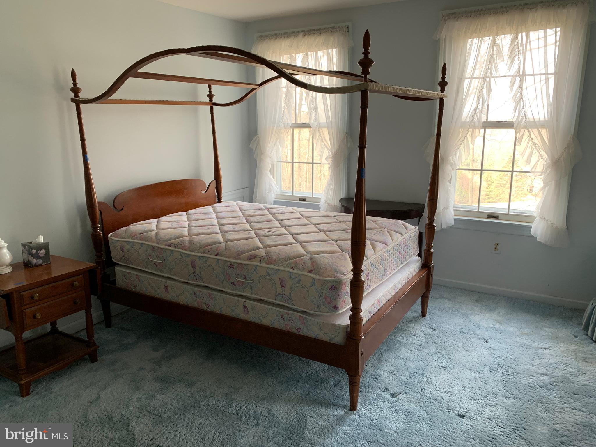 7603 Irongate Lane Frederick, MD 21702 - Photo 36 of 43 a bed sitting in a bedroom next to a window