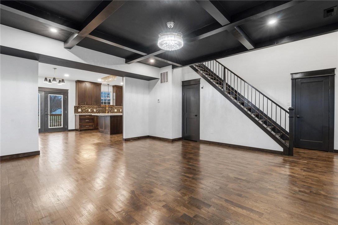 3509 South State Rte 72 Sabina, OH 45169 - Photo 6 of 44 This expansive interior features striking architectural details and rich hardwood flooring, creating an inviting atmosphere.