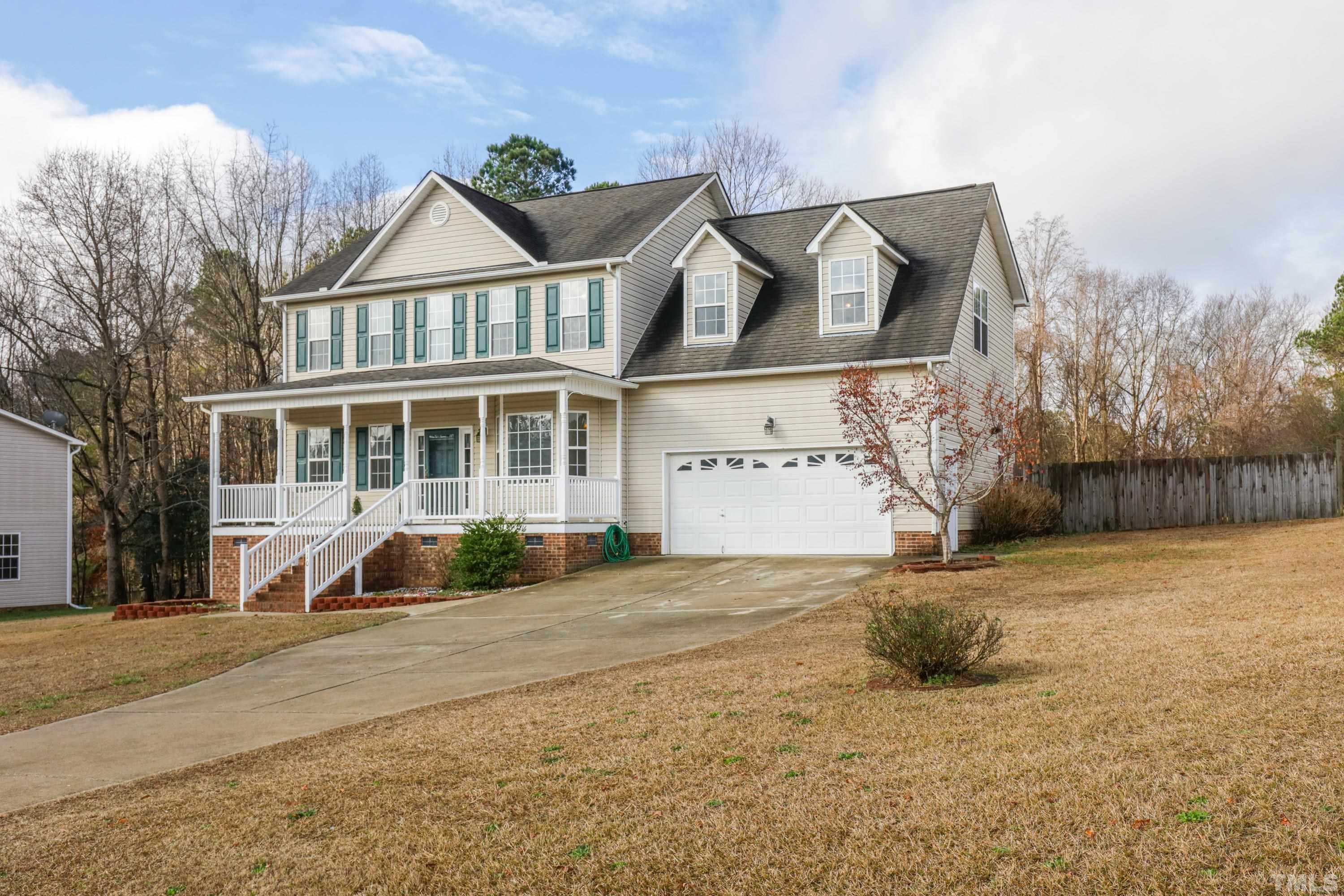 110 Saddle Ridge Drive Willow Spring, NC 27592 - Photo 2 of 32 a front view of a house with a yard