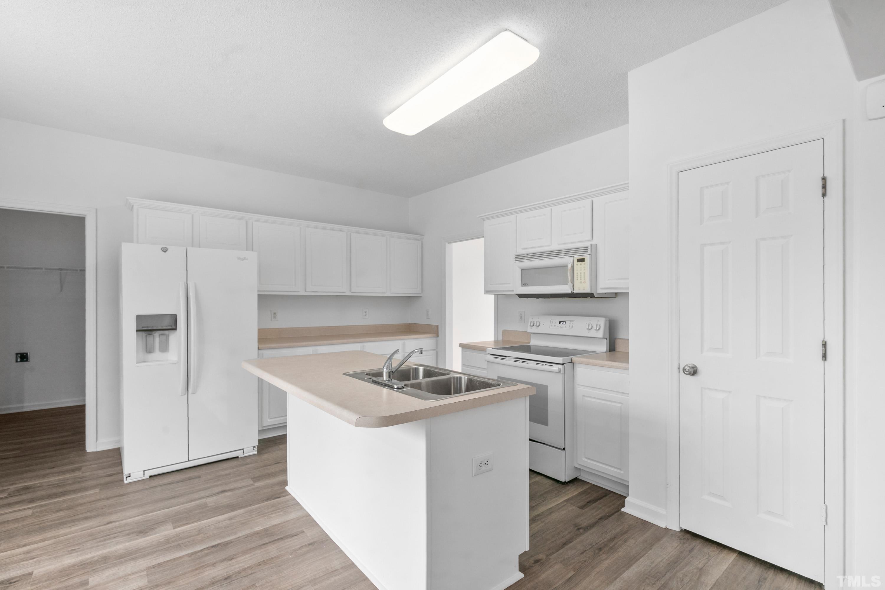 110 Saddle Ridge Drive Willow Spring, NC 27592 - Photo 11 of 32 a kitchen that has a sink and a stove in it