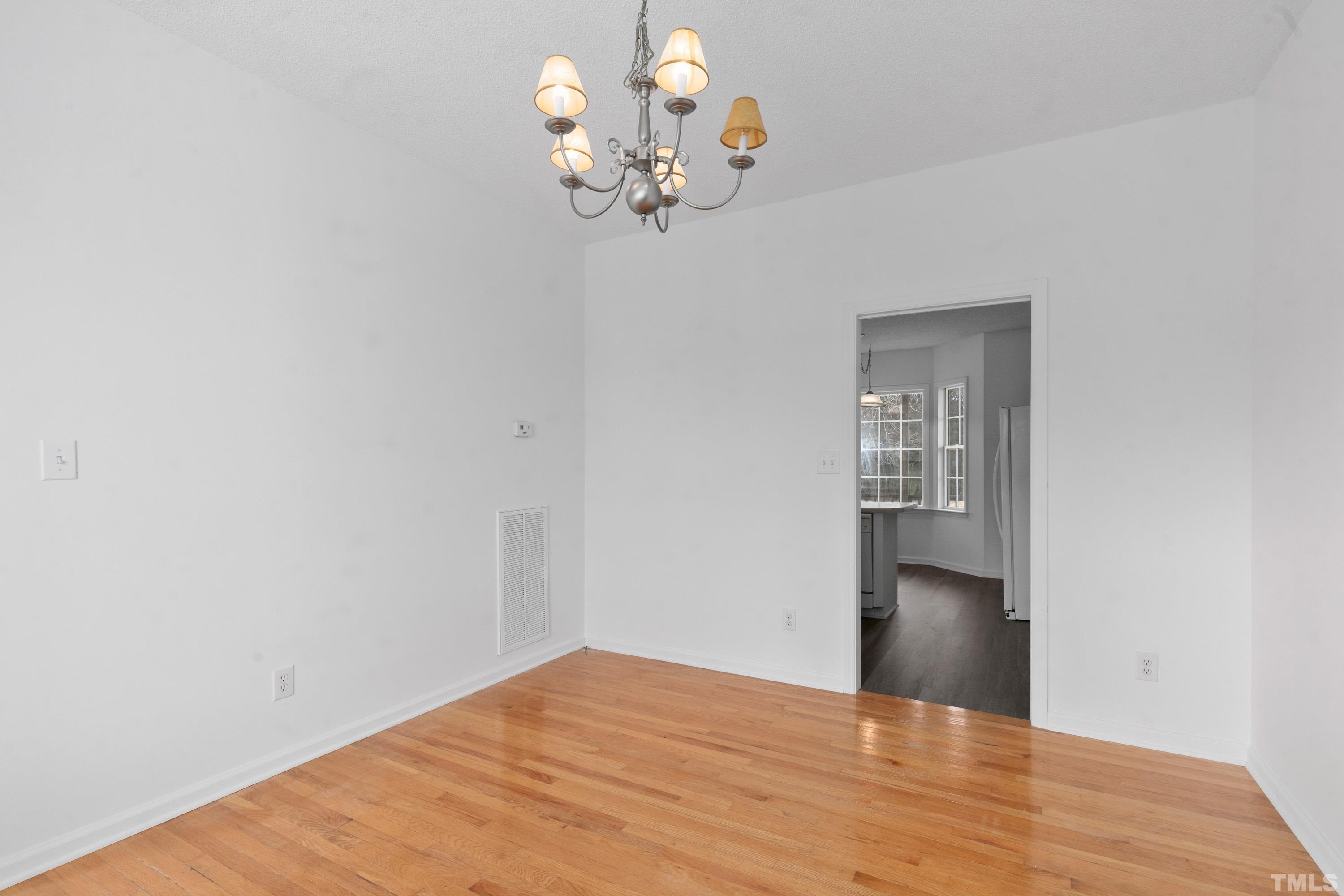 110 Saddle Ridge Drive Willow Spring, NC 27592 - Photo 16 of 32 a view of a room with wooden floor and chandelier