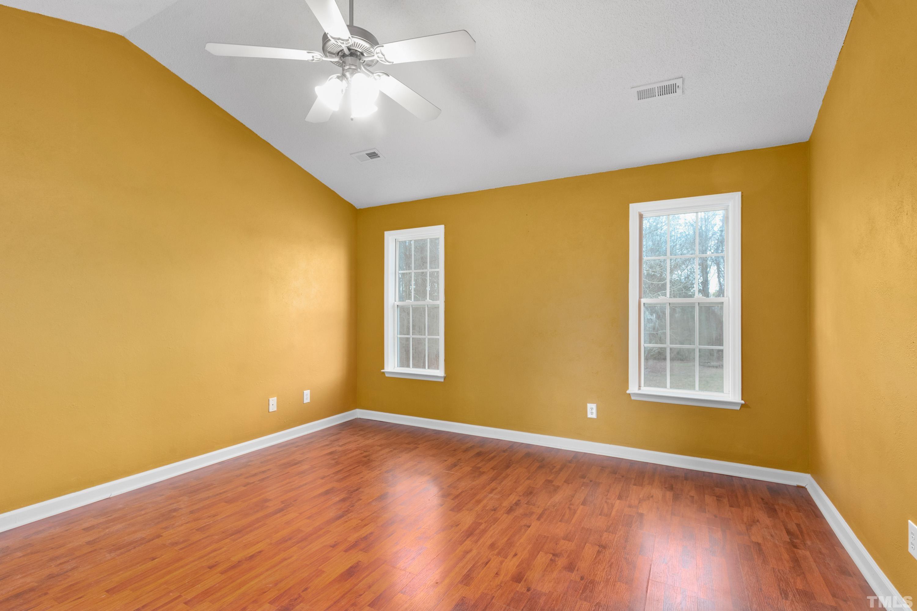 110 Saddle Ridge Drive Willow Spring, NC 27592 - Photo 18 of 32 a view of an empty room with wooden floor and a window