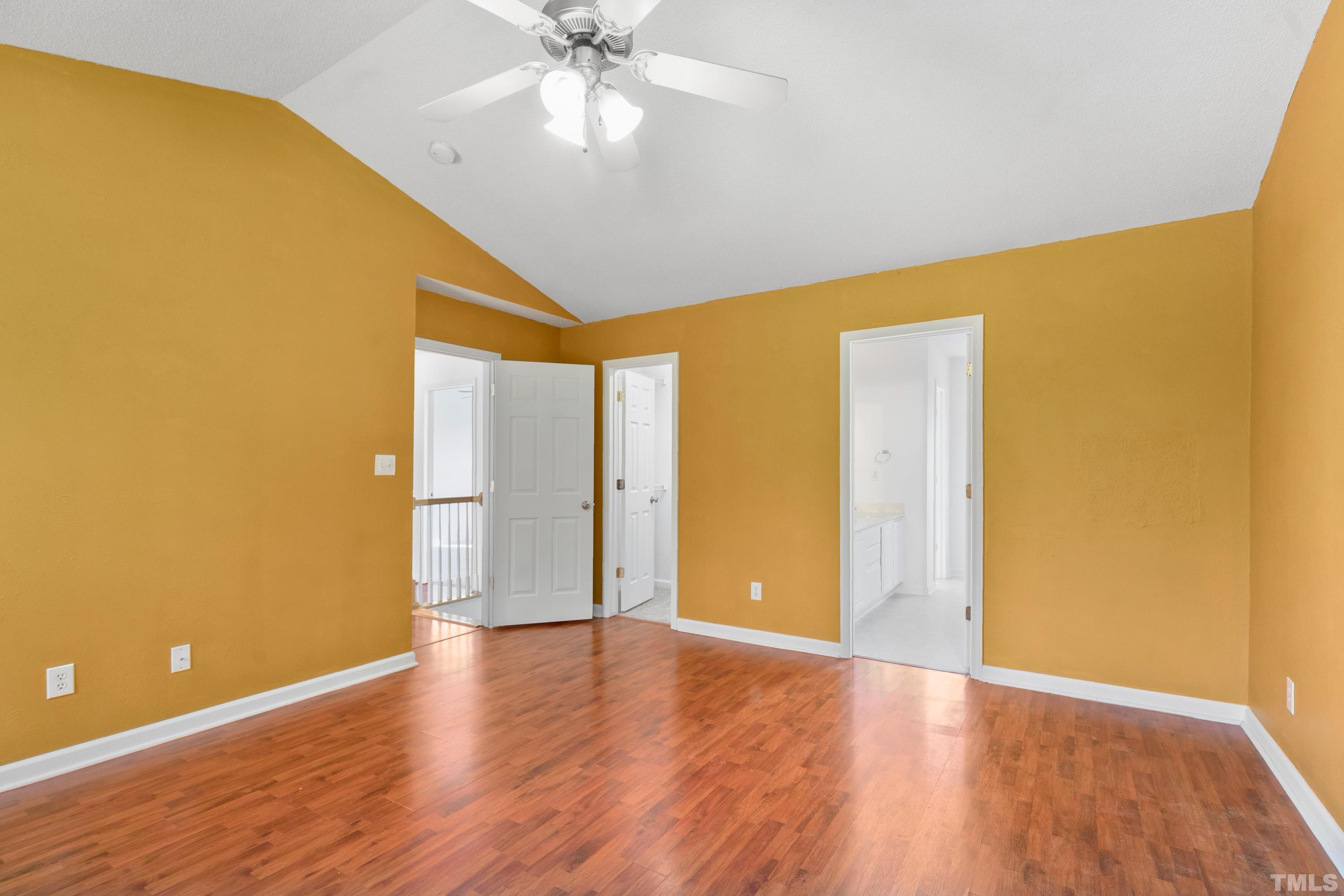 110 Saddle Ridge Drive Willow Spring, NC 27592 - Photo 19 of 32 a view of an empty room with wooden floor and a ceiling fan