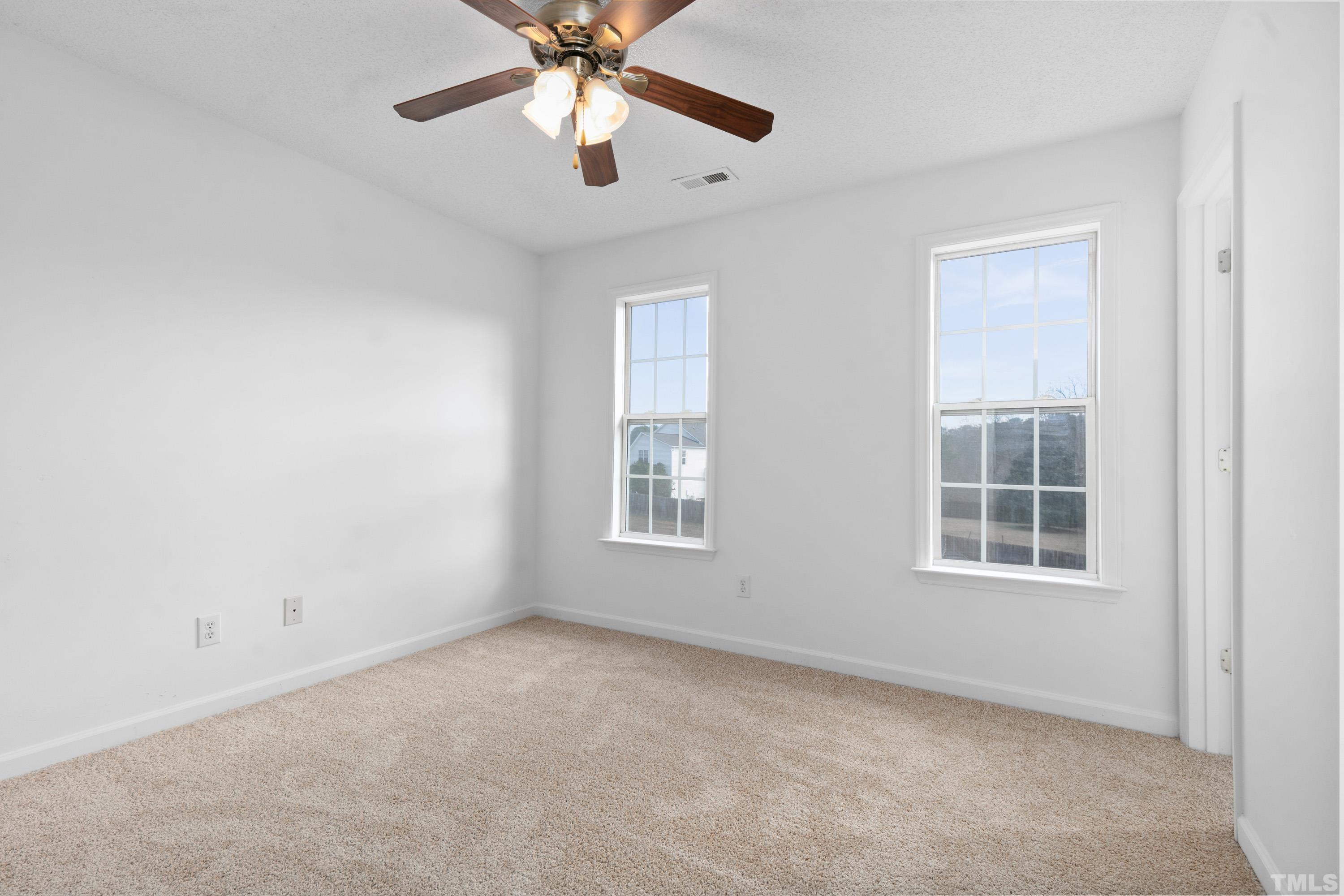 110 Saddle Ridge Drive Willow Spring, NC 27592 - Photo 25 of 32 an empty room with a window and a fan