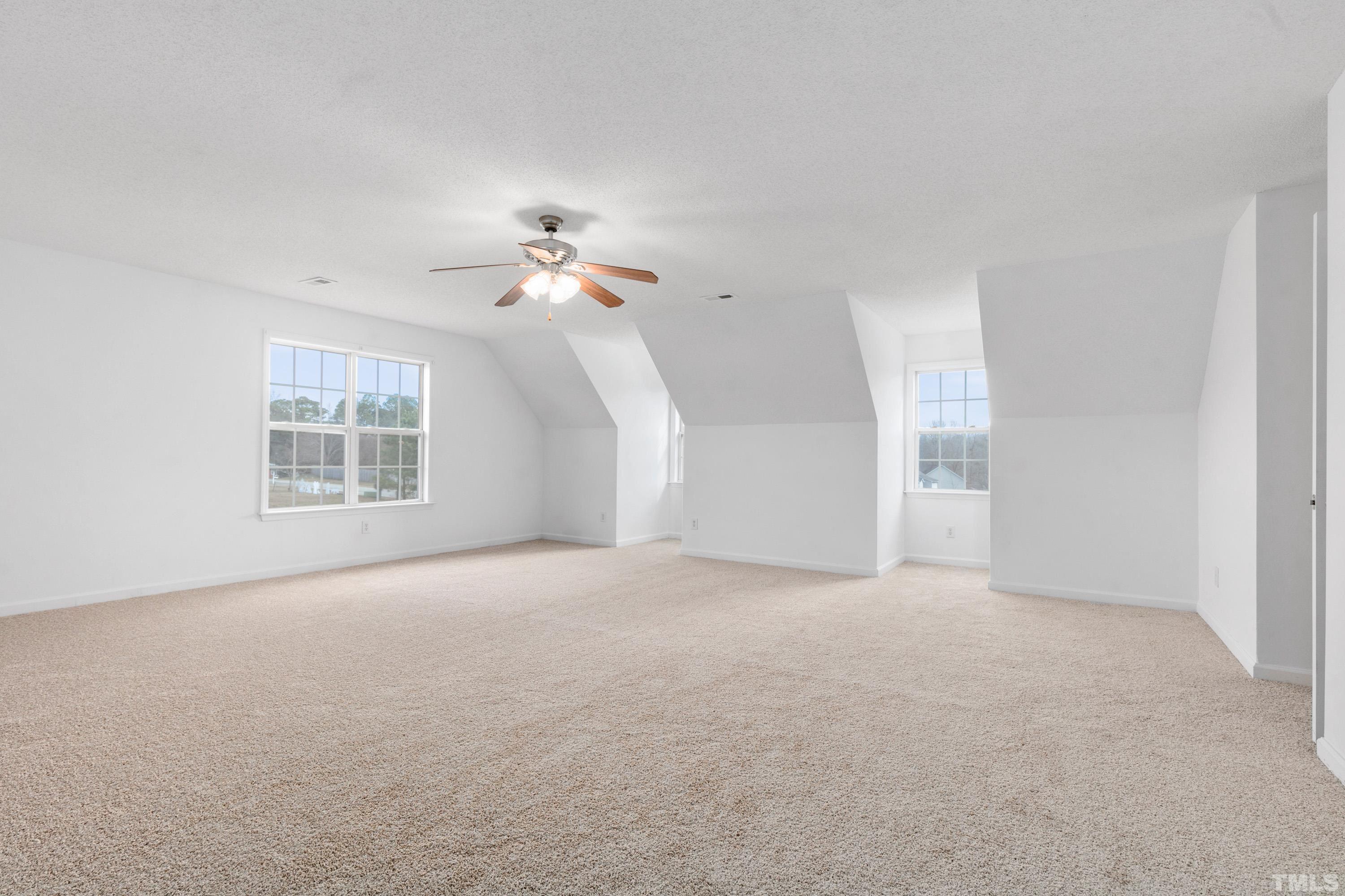 110 Saddle Ridge Drive Willow Spring, NC 27592 - Photo 27 of 32 a view of a big room with windows and chandelier fan