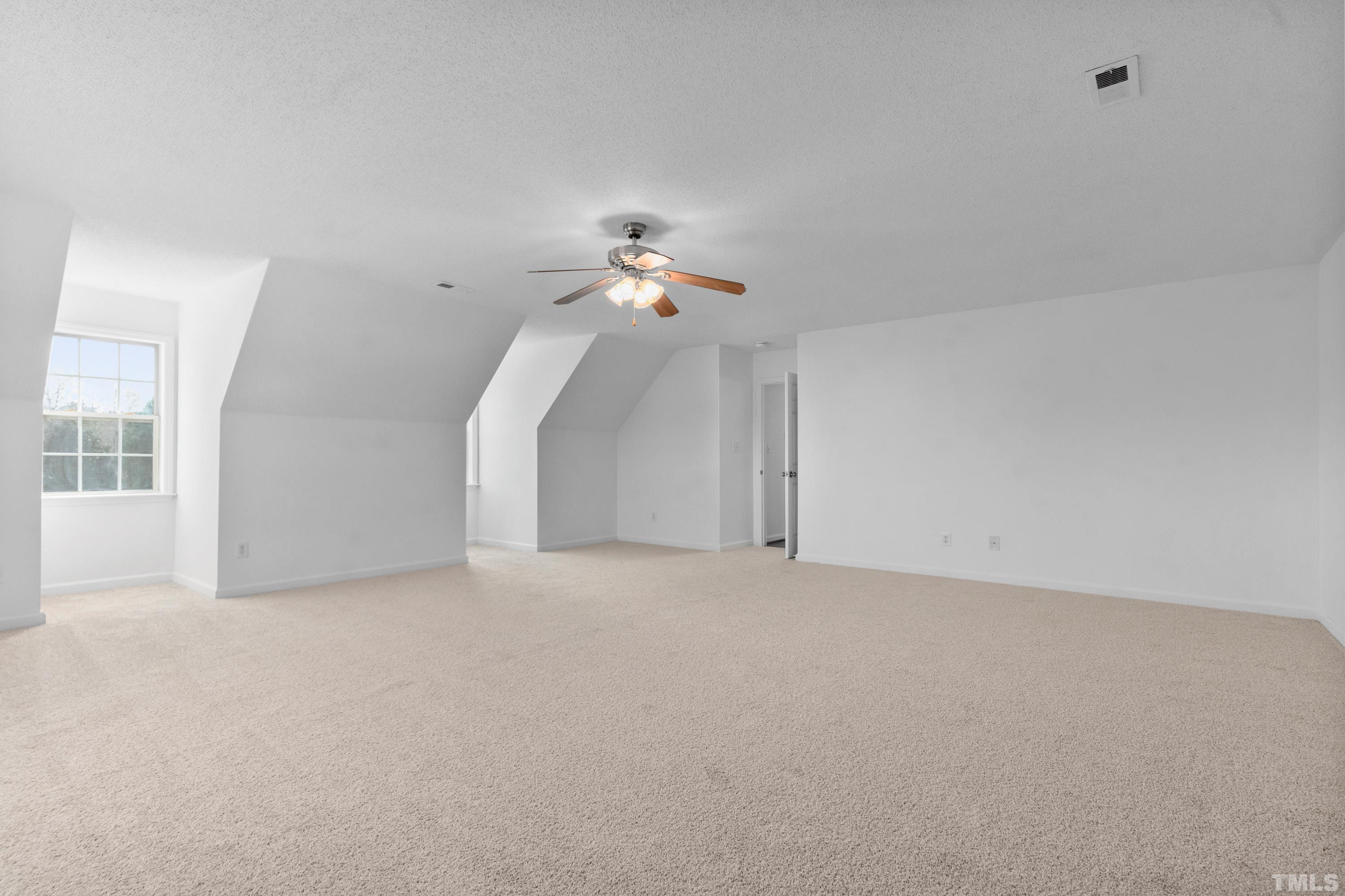 110 Saddle Ridge Drive Willow Spring, NC 27592 - Photo 28 of 32 a view of a room with a ceiling fan and window