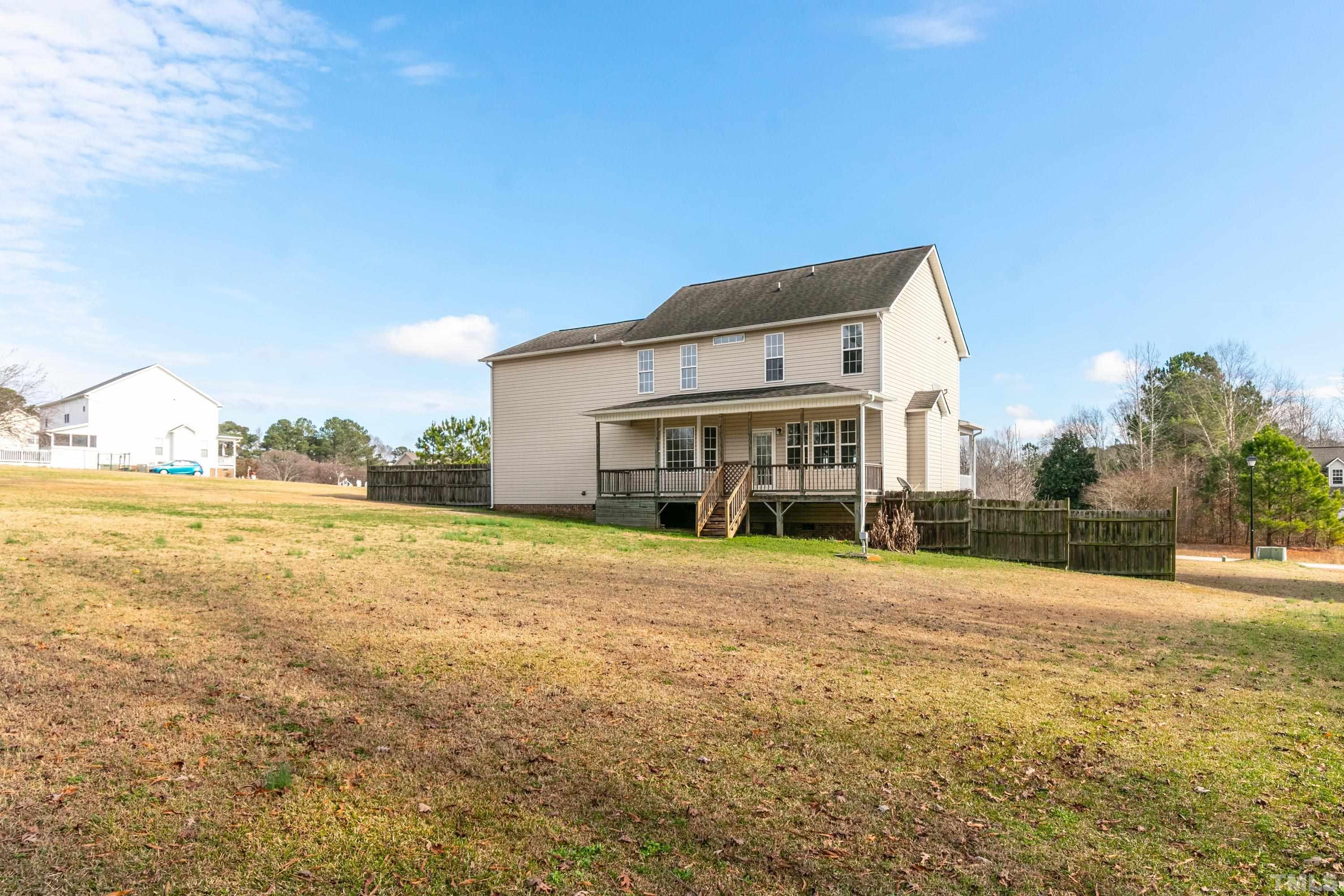 110 Saddle Ridge Drive Willow Spring, NC 27592 - Photo 29 of 32 a view of a house with a big yard and large trees