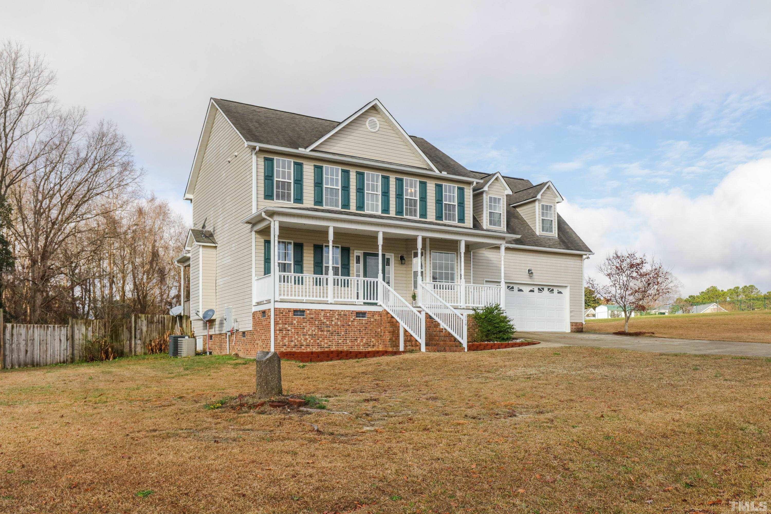 110 Saddle Ridge Drive Willow Spring, NC 27592 - Photo 4 of 32 a front view of a house with a yard