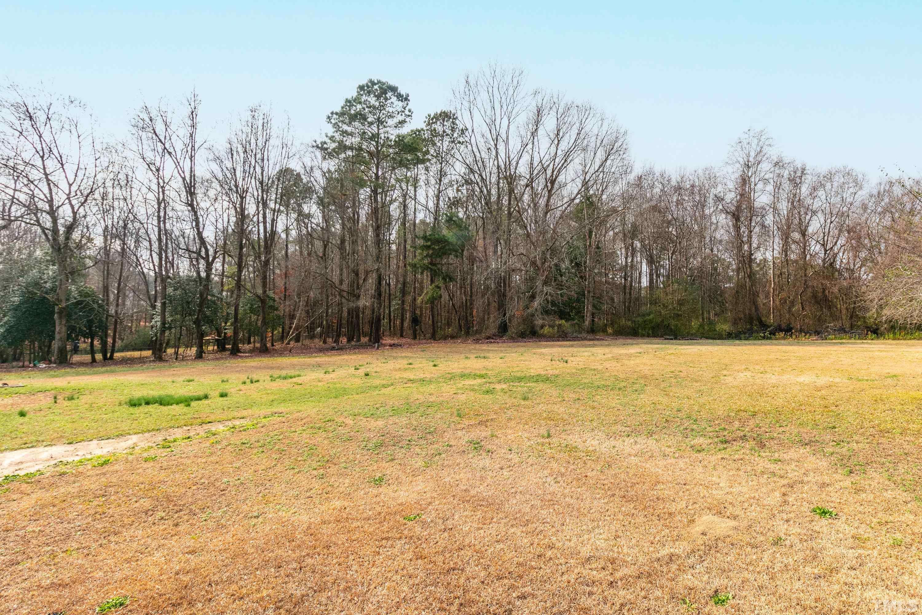 110 Saddle Ridge Drive Willow Spring, NC 27592 - Photo 32 of 32 a view of a swimming pool and trees