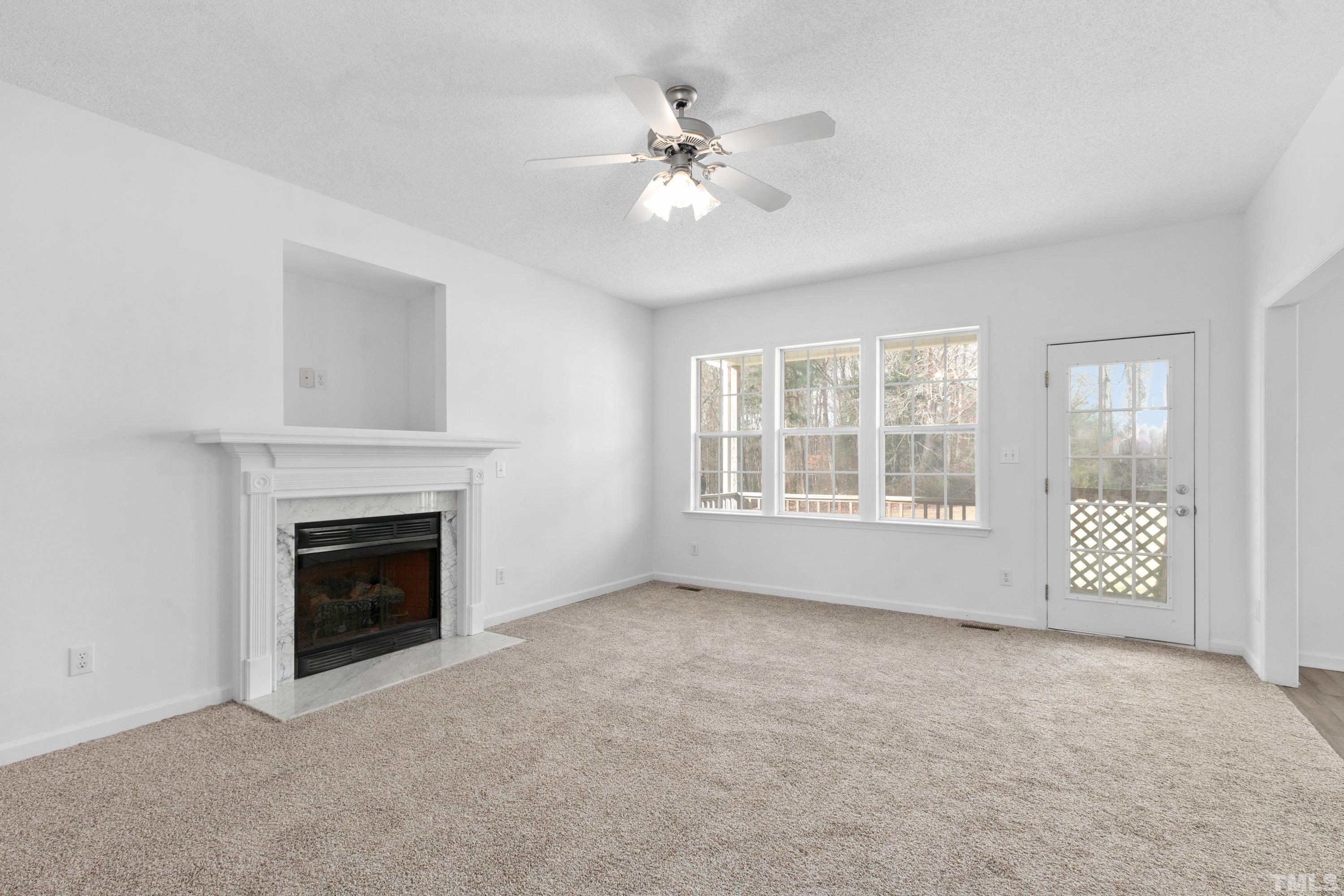 110 Saddle Ridge Drive Willow Spring, NC 27592 - Photo 6 of 32 an empty room with windows and fireplace