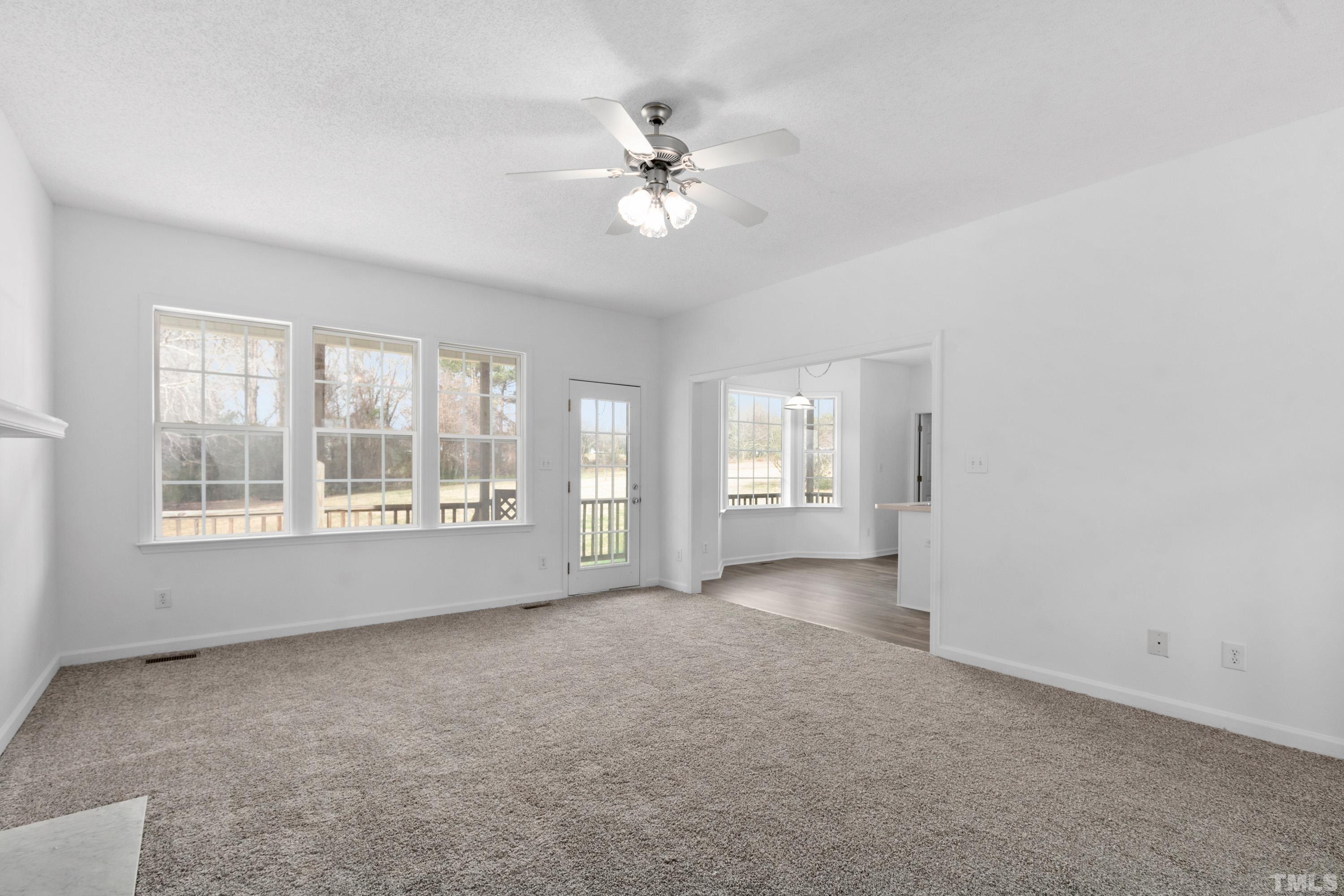 110 Saddle Ridge Drive Willow Spring, NC 27592 - Photo 7 of 32 a view of a livingroom with a ceiling fan and window