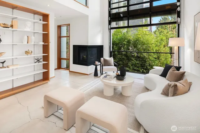 a living room with furniture a lamp and a large window