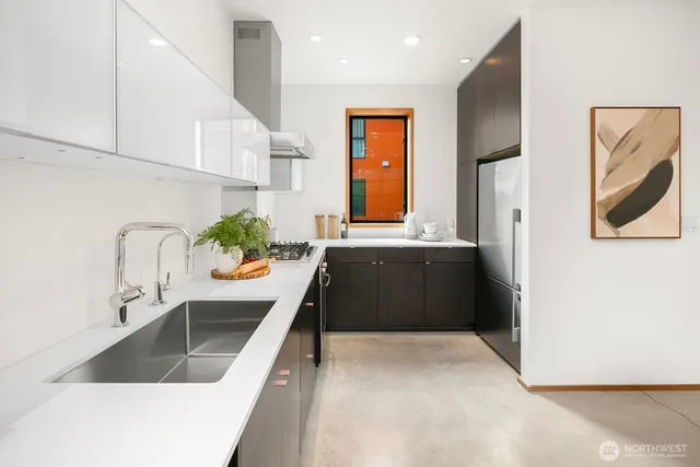 a kitchen with a sink stove and a refrigerator