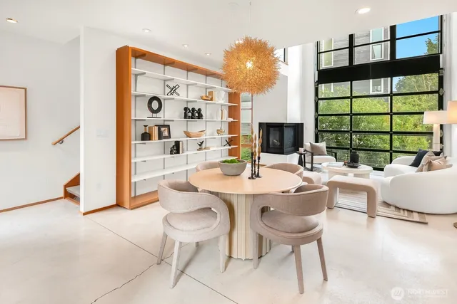 a dining room with furniture and a large window