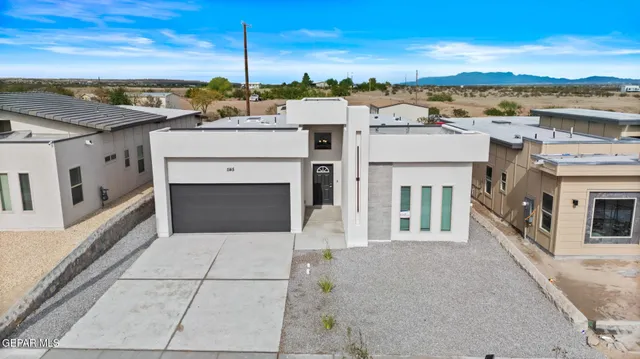 a view of a white house with a outdoor space
