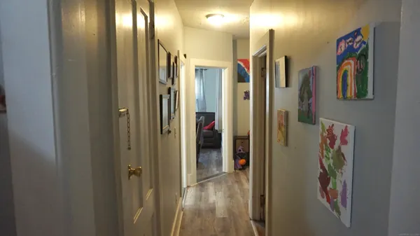 a view of an entryway with wooden floor