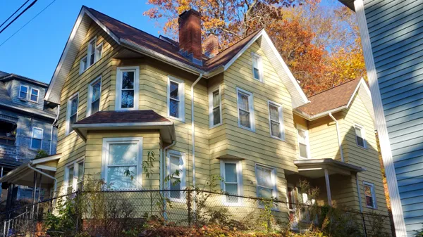 a view of a brick house with a large windows