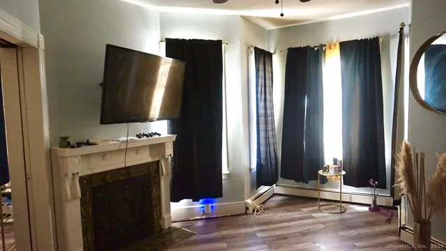 a view of a dining room with furniture and chandelier