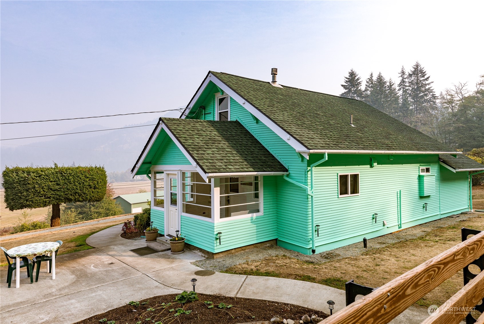 4736 Sharpe Road Anacortes, WA 98221 - Photo 14 of 40 a view of a house with a backyard