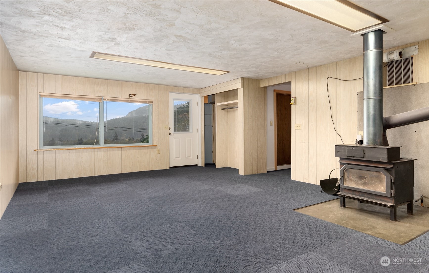 4736 Sharpe Road Anacortes, WA 98221 - Photo 24 of 40 a view of a livingroom with furniture and floor to ceiling window