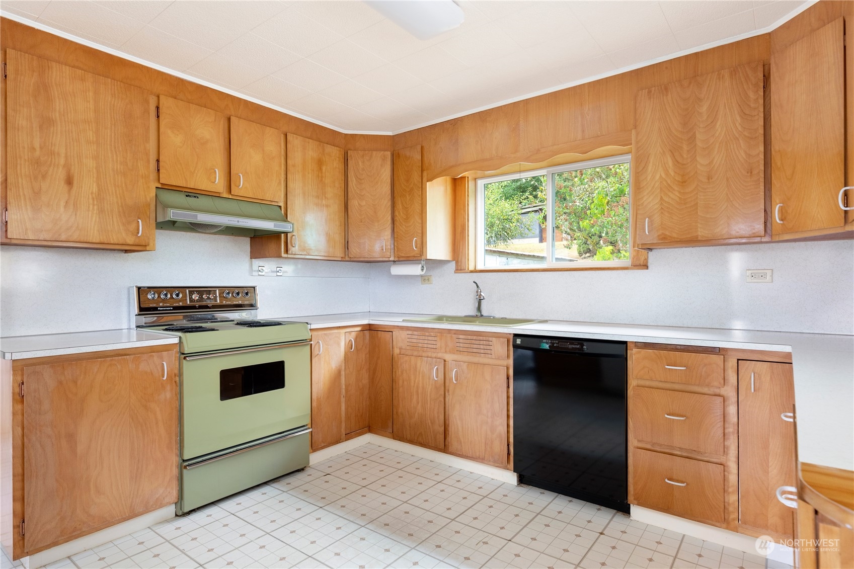 4736 Sharpe Road Anacortes, WA 98221 - Photo 8 of 40 a kitchen with granite countertop wooden cabinets stainless steel appliances and a window
